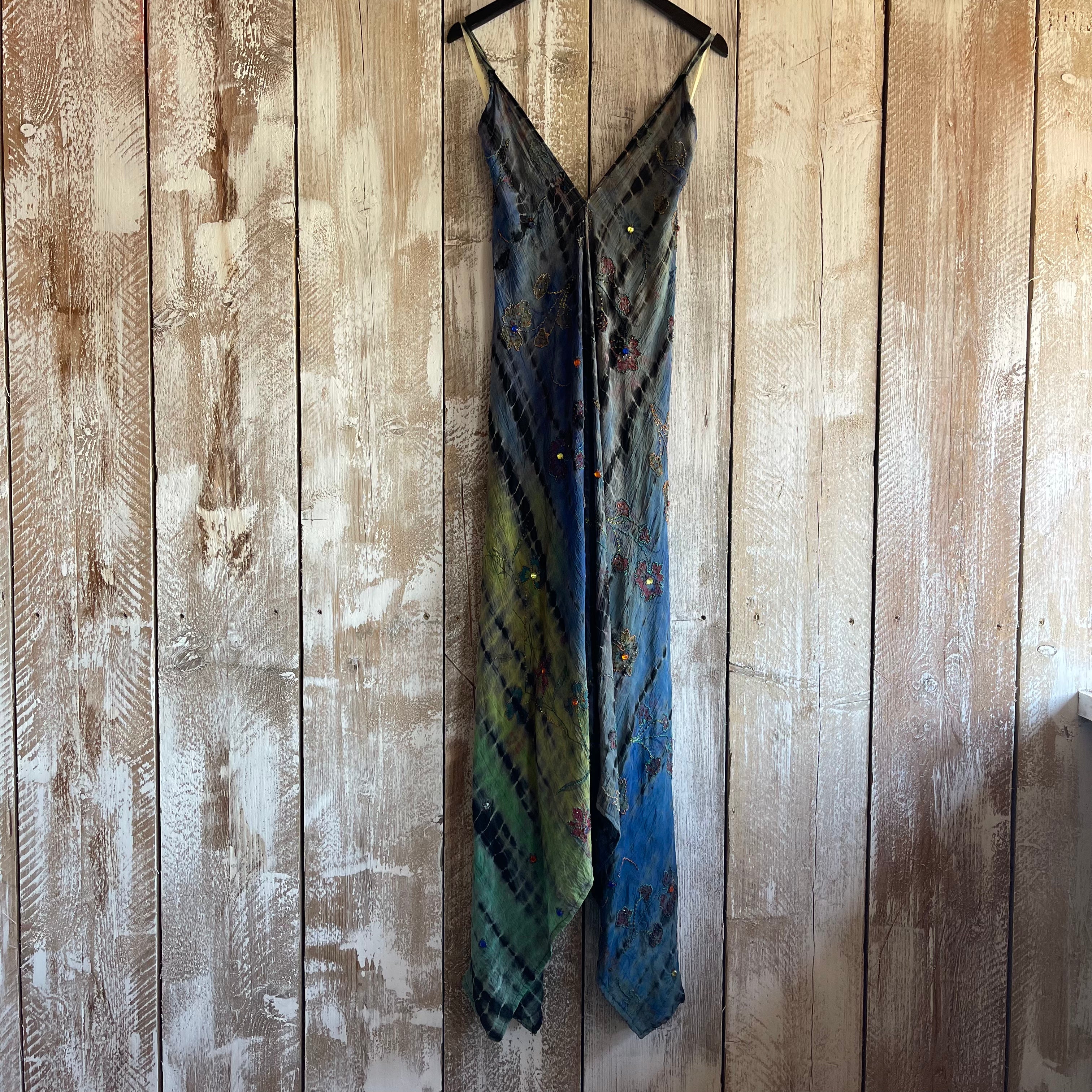 Multicolored dress hanging on a wooden panel wall