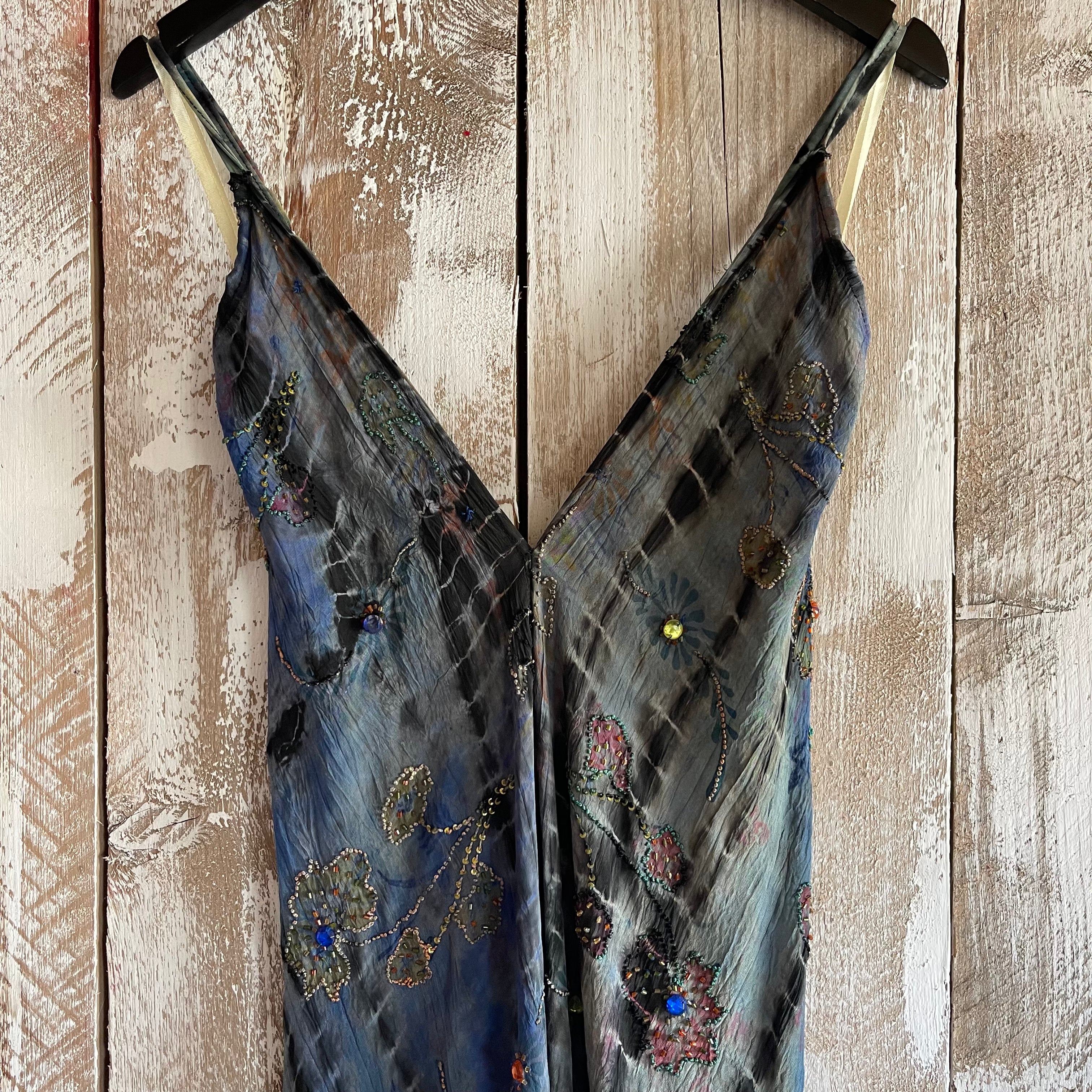 Blue embroidered dress on a wooden surface