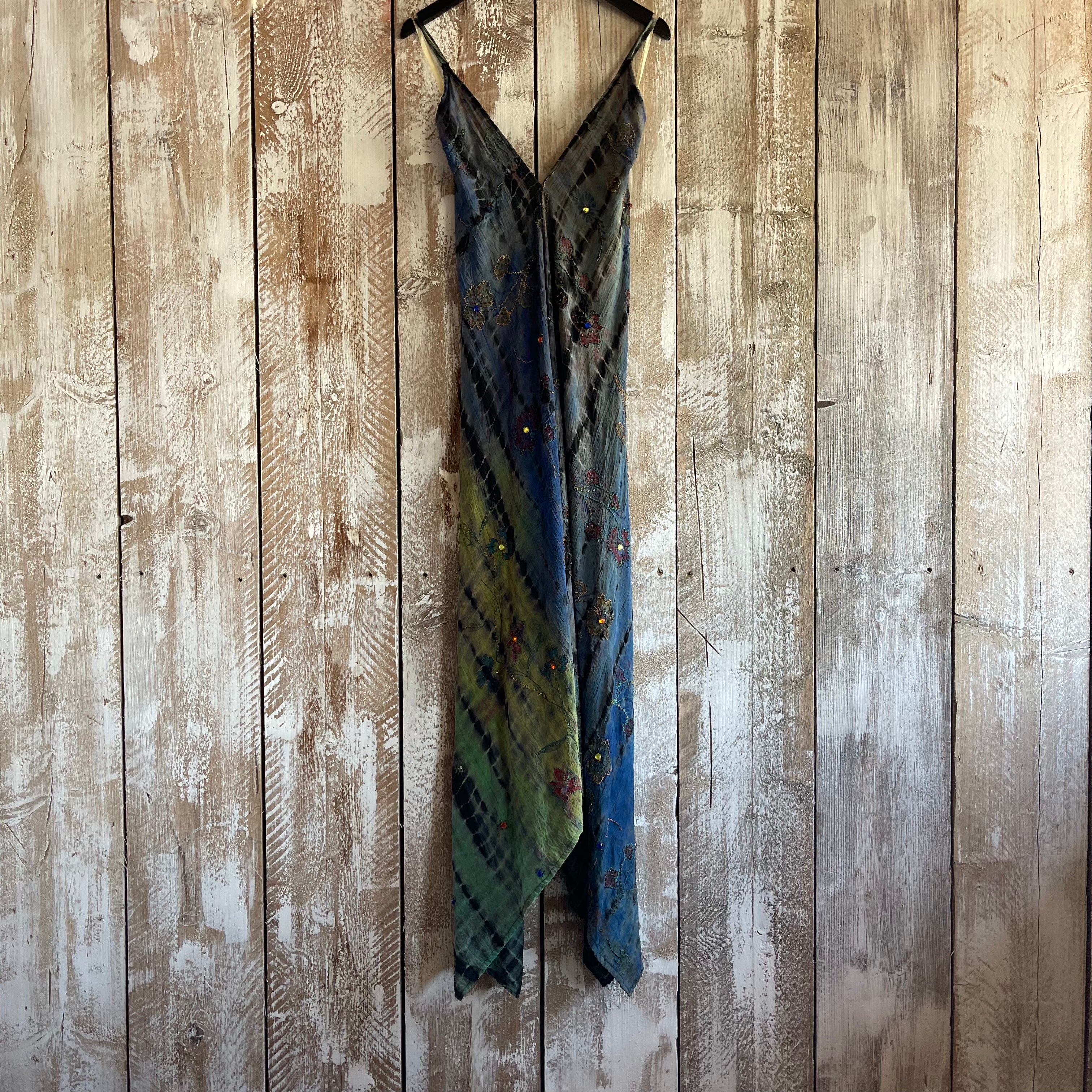 Plaid dress hanging on a wooden panel wall