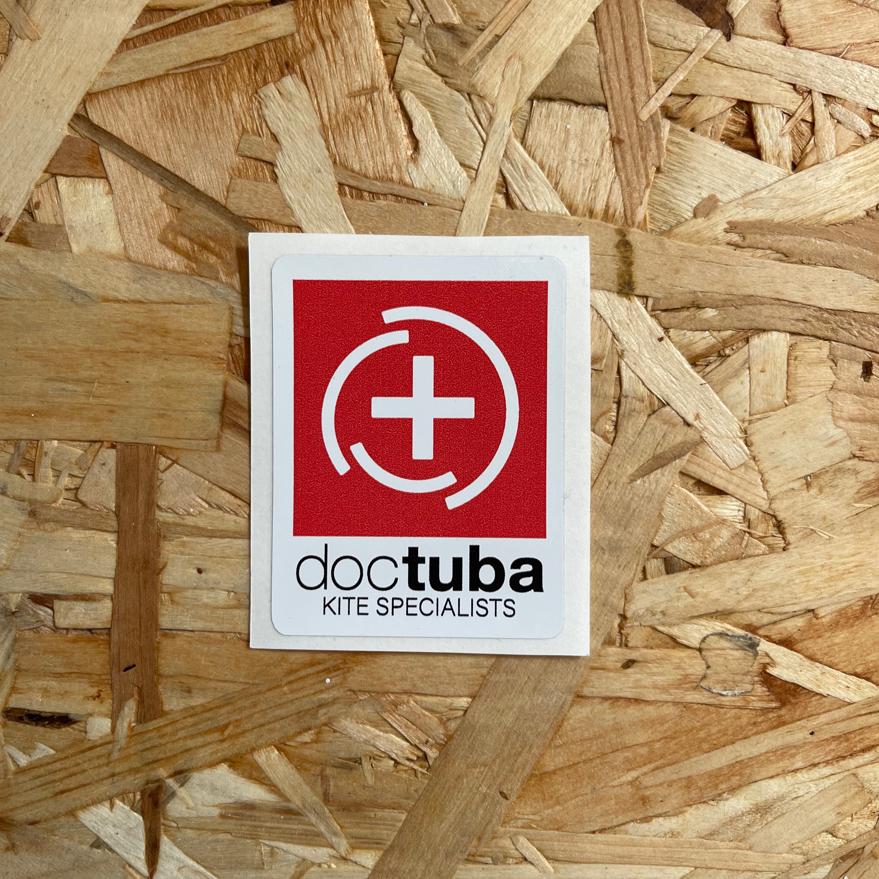 Doctuba kite specialists logo on a wooden background