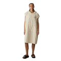 Person wearing a beige hooded dress against a gray background