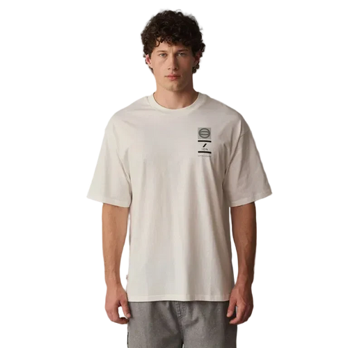 Man wearing a beige t-shirt with a logo on a gray background