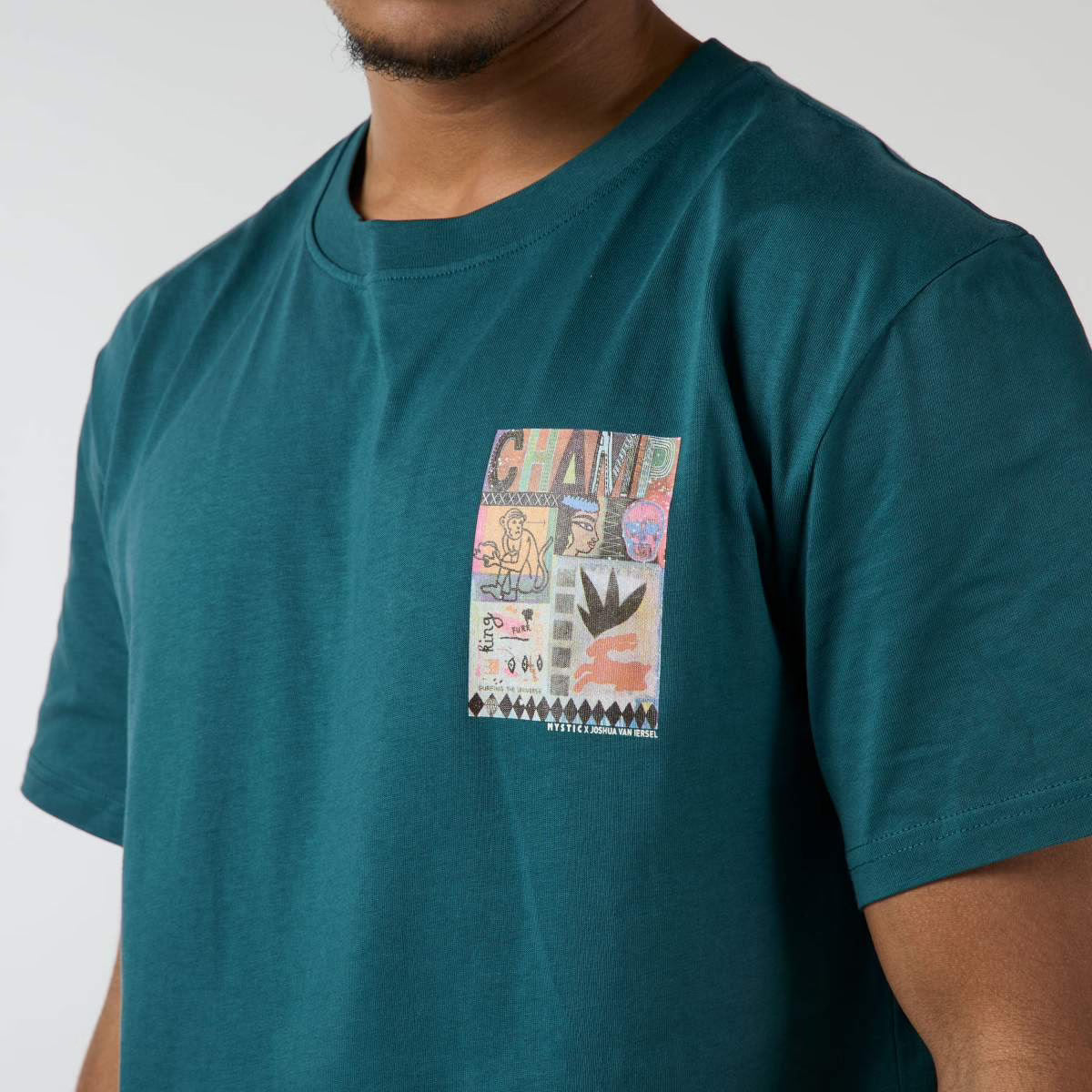 Teal t-shirt with a colorful graphic on a plain background