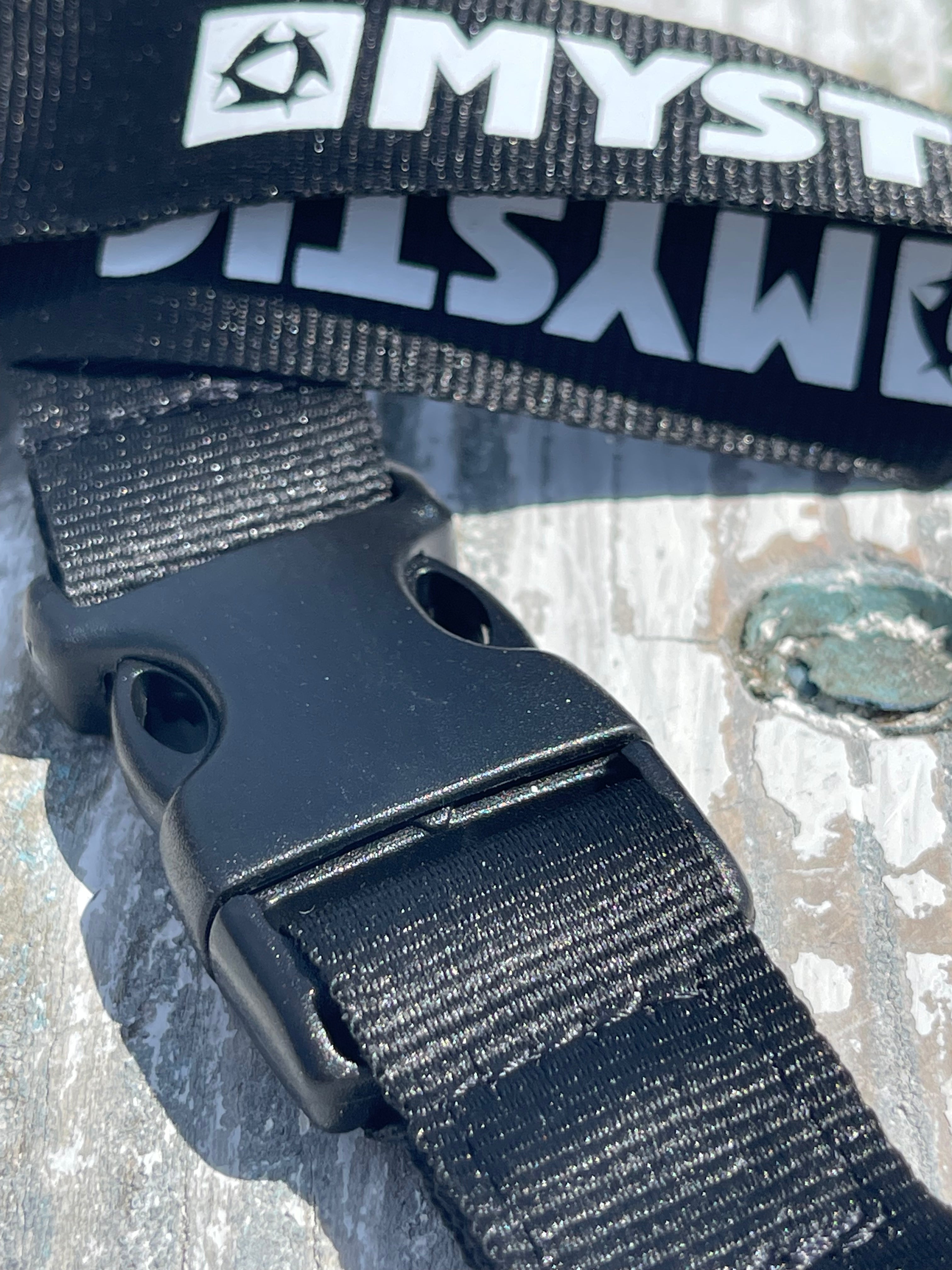 Black strap with a Myst logo on a textured surface