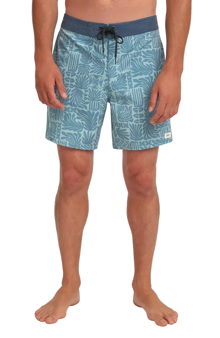 Person wearing blue patterned shorts on a white background