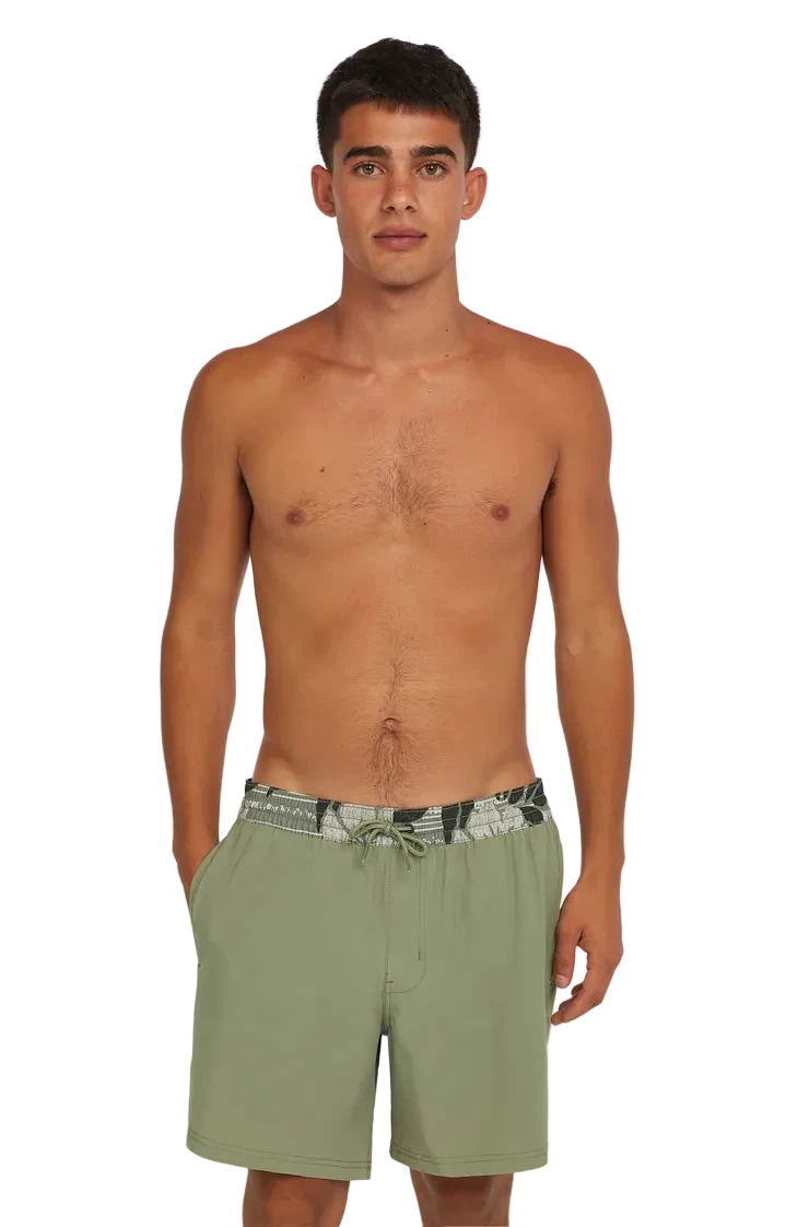 Man wearing green swim shorts on a white background