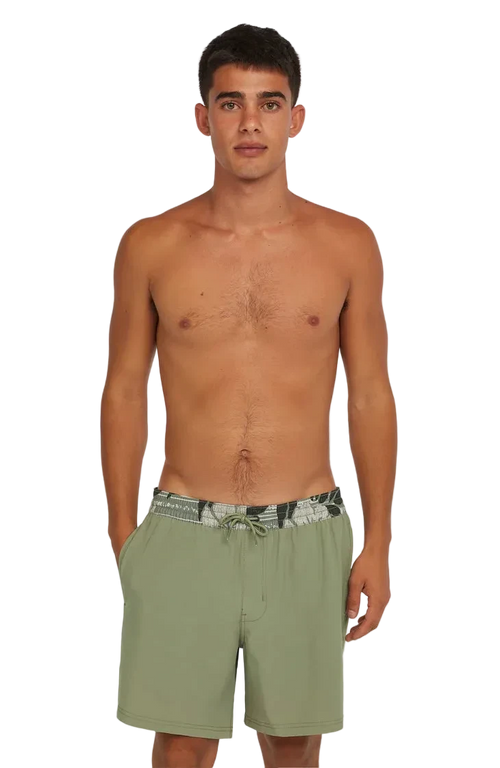 Man wearing green swim shorts on a white background