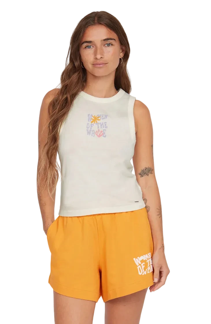 Woman wearing a white sleeveless top and orange shorts with text on a plain background
