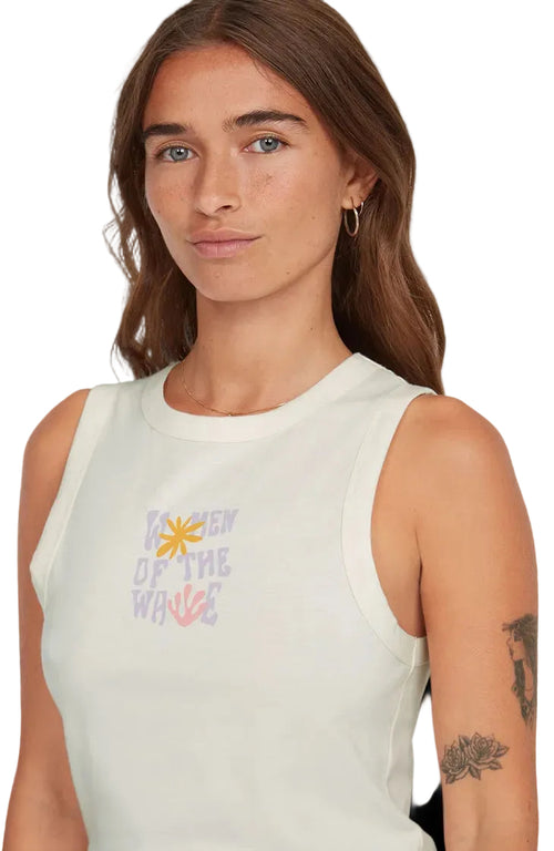 Woman wearing a sleeveless top with a colorful graphic design on a plain background